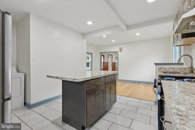 603 Vernon St, Media, PA 19063 - kitchen featuring washer / dryer, recessed lighting, a sink, a center island, and light tile patterned flooring