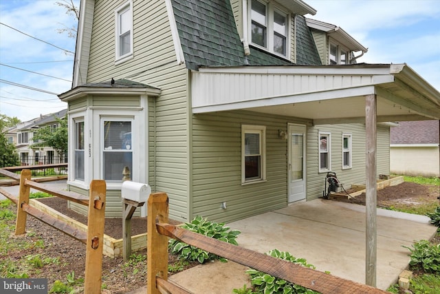603 Vernon St, Media, PA 19063 - view of home's exterior with a gambrel roof, a patio area, and a shingled roof