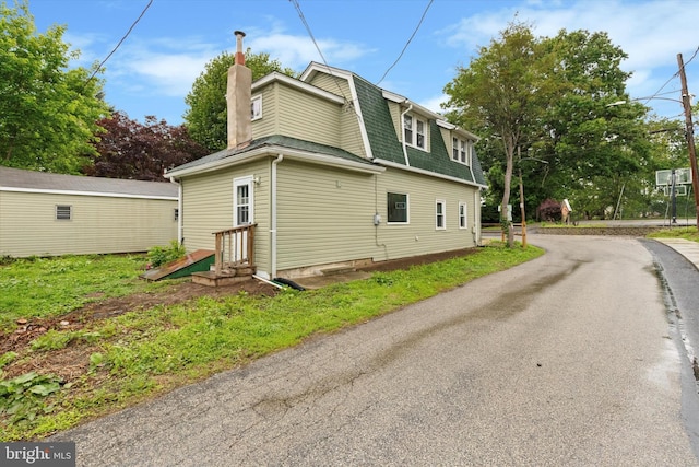 603 Vernon St, Media, PA 19063 - view of side of home with entry steps, a chimney, and roof with shingles