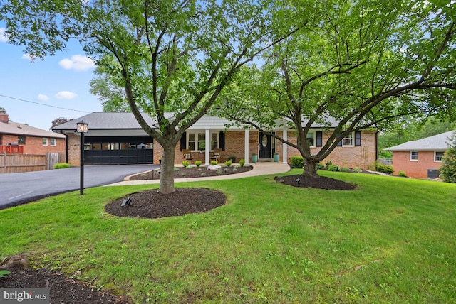 2302 Solmar Dr, Silver Spring, MD 20904 - view of front of home featuring curved driveway, an attached garage, and brick siding