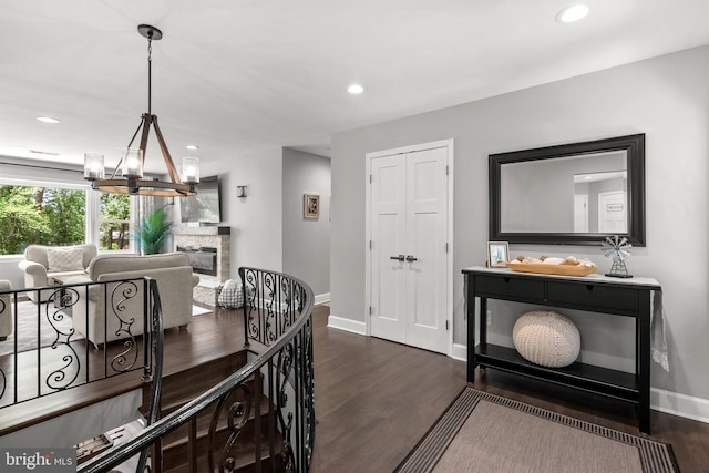 2302 Solmar Dr, Silver Spring, MD 20904 - dining space with dark wood-style flooring, baseboards, a chandelier, recessed lighting, and a stone fireplace