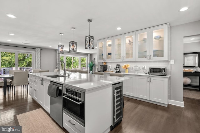 2302 Solmar Dr, Silver Spring, MD 20904 - kitchen with a sink, stainless steel appliances, beverage cooler, white cabinetry, and recessed lighting
