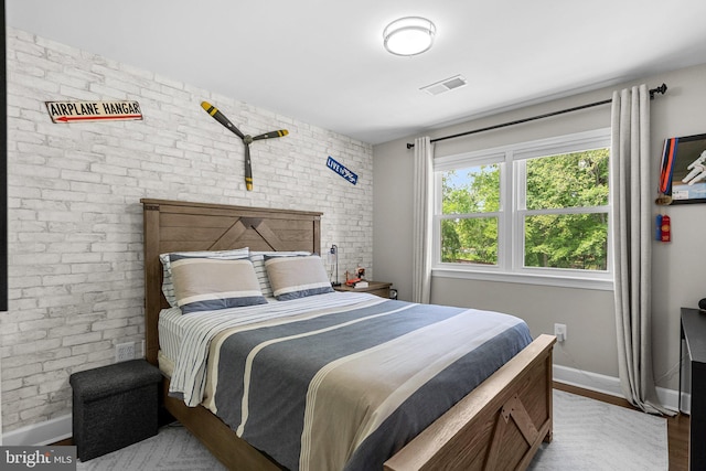 2302 Solmar Dr, Silver Spring, MD 20904 - bedroom with baseboards, brick wall, and wood finished floors