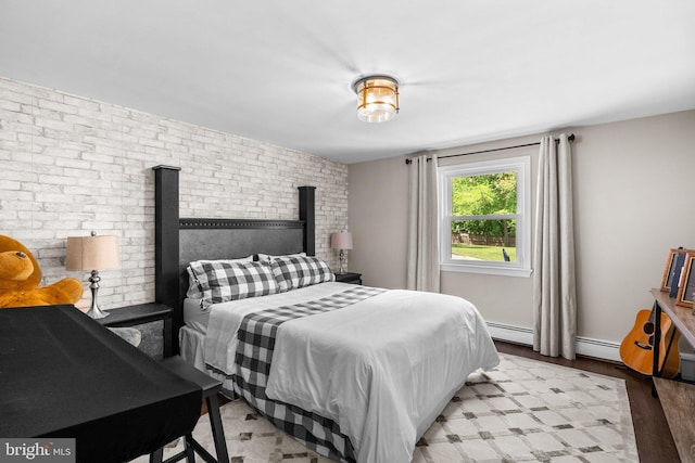 2302 Solmar Dr, Silver Spring, MD 20904 - bedroom with brick wall, a baseboard heating unit, and light wood finished floors