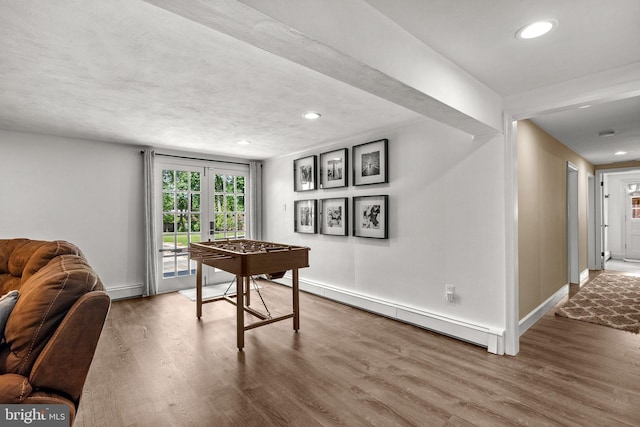 2302 Solmar Dr, Silver Spring, MD 20904 - rec room with a baseboard radiator, wood finished floors, recessed lighting, and baseboards