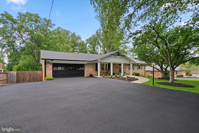 2302 Solmar Dr, Silver Spring, MD 20904 - view of front of house with driveway, a garage, brick siding, and a shingled roof