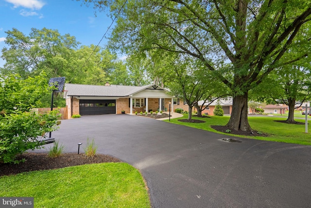 2302 Solmar Dr, Silver Spring, MD 20904 - single story home with an attached garage, driveway, brick siding, and a chimney