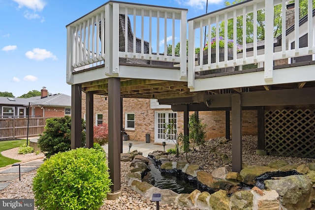 2302 Solmar Dr, Silver Spring, MD 20904 - rear view of property featuring brick siding, a garden pond, a patio, and a deck