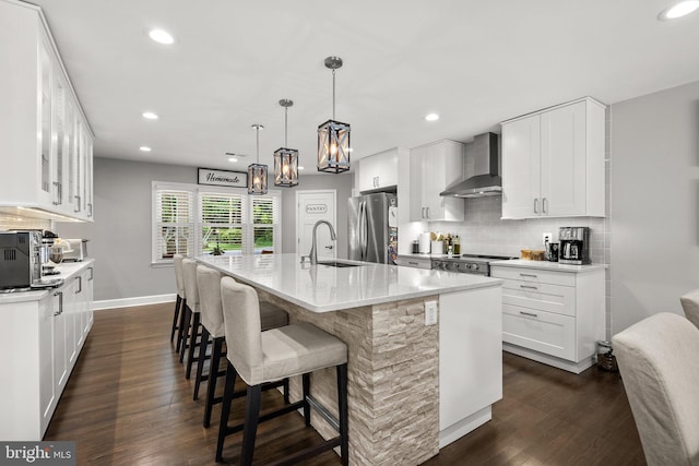 2302 Solmar Dr, Silver Spring, MD 20904 - kitchen with wall chimney range hood, appliances with stainless steel finishes, dark wood-type flooring, recessed lighting, and tasteful backsplash