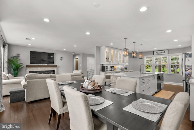 2302 Solmar Dr, Silver Spring, MD 20904 - dining room with recessed lighting, dark wood finished floors, and a fireplace