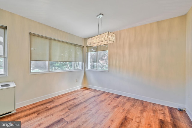 3601 5th St S Unit 211, Arlington, VA 22204 - empty room featuring a chandelier, wood finished floors, and baseboards