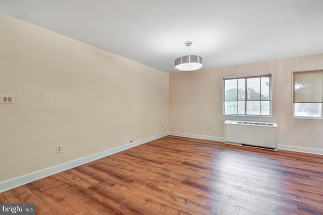 3601 5th St S Unit 211, Arlington, VA 22204 - unfurnished room featuring radiator heating unit, baseboards, and wood finished floors