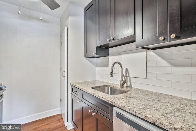 3601 5th St S Unit 211, Arlington, VA 22204 - kitchen with a sink, light wood-style floors, baseboards, decorative backsplash, and light stone countertops