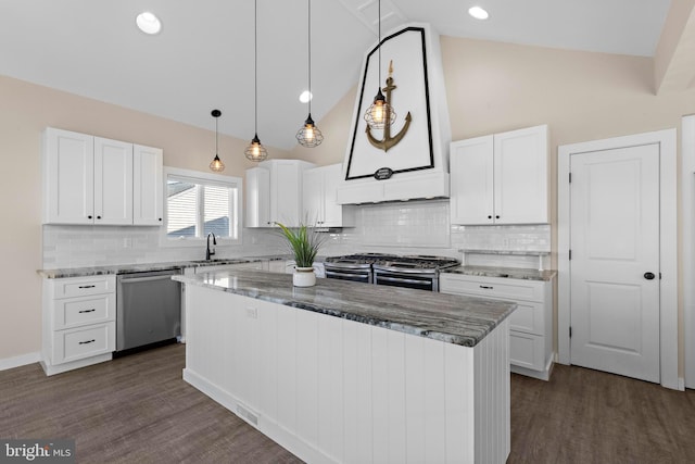 1169 Jennifer Ln, Manahawkin, NJ 08050 - kitchen with stainless steel appliances, a sink, a center island, light stone counters, and white cabinetry