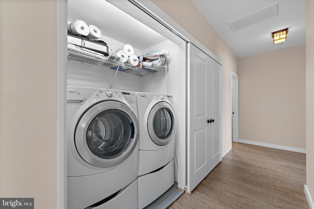 1169 Jennifer Ln, Manahawkin, NJ 08050 - laundry room with baseboards, independent washer and dryer, and light wood-style floors
