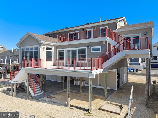 1169 Jennifer Ln, Manahawkin, NJ 08050 - rear view of property featuring stairway, a carport, roof with shingles, and a deck
