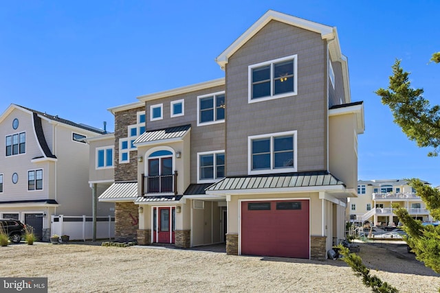 1169 Jennifer Ln, Manahawkin, NJ 08050 - view of front of property with stone siding, a standing seam roof, driveway, an attached garage, and metal roof