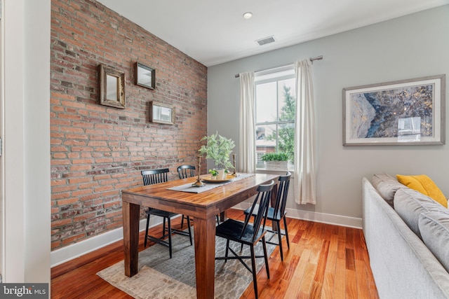 2031 Pine St Unit 4, Philadelphia, PA 19103 - dining area with baseboards, light wood-type flooring, and brick wall