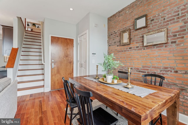 2031 Pine St Unit 4, Philadelphia, PA 19103 - dining room featuring wood finished floors, stairway, baseboards, and brick wall