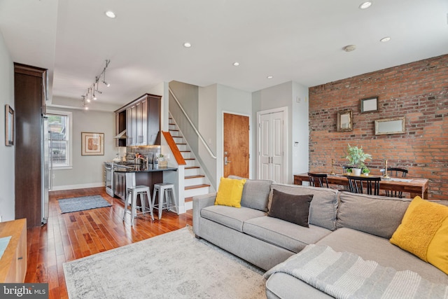 2031 Pine St Unit 4, Philadelphia, PA 19103 - living area with stairs, hardwood / wood-style floors, baseboards, brick wall, and recessed lighting