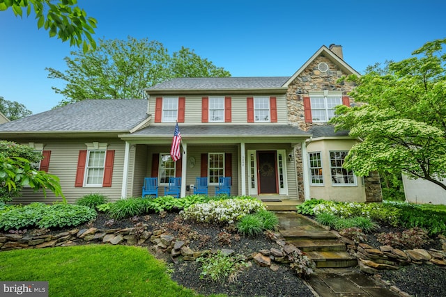 3858 Johns Way, Doylestown, PA 18902 - view of front of home featuring covered porch, a chimney, stone siding, and roof with shingles