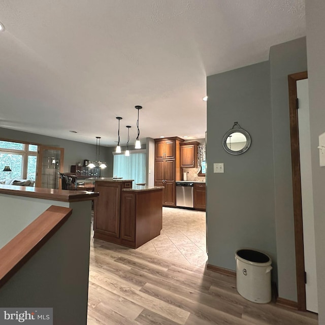 8201 Michaux Dr, Fayetteville, PA 17222 - kitchen with dishwasher, light wood-type flooring, hanging light fixtures, decorative backsplash, and a center island