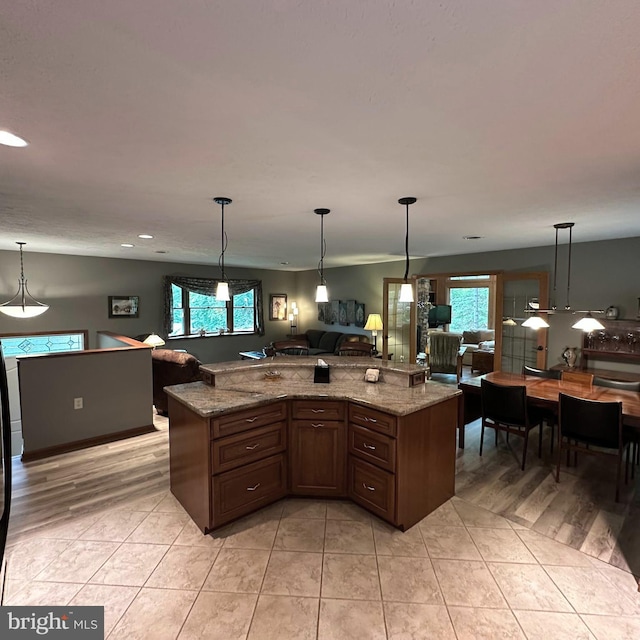 8201 Michaux Dr, Fayetteville, PA 17222 - kitchen featuring open floor plan, light tile patterned flooring, decorative light fixtures, recessed lighting, and light stone counters