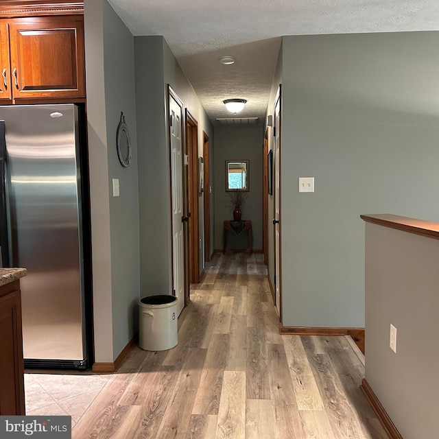 8201 Michaux Dr, Fayetteville, PA 17222 - hall featuring a textured ceiling, light wood finished floors, and baseboards