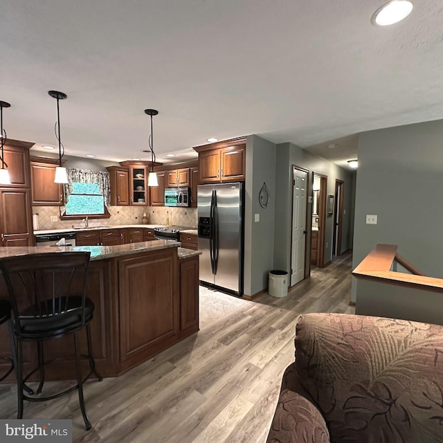 8201 Michaux Dr, Fayetteville, PA 17222 - kitchen with stainless steel appliances, backsplash, light wood finished floors, hanging light fixtures, and recessed lighting