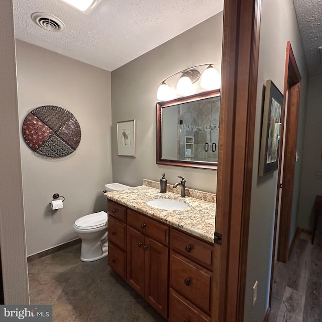 8201 Michaux Dr, Fayetteville, PA 17222 - full bath with a textured ceiling, vanity, toilet, baseboards, and a shower