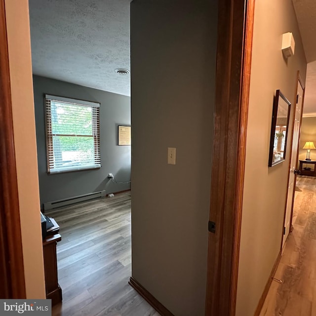 8201 Michaux Dr, Fayetteville, PA 17222 - hallway featuring a baseboard radiator, wood finished floors, and a textured ceiling