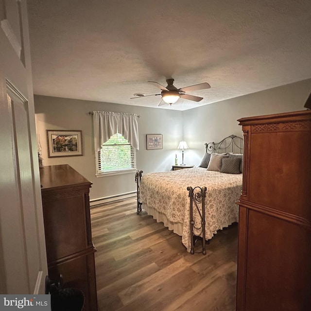 8201 Michaux Dr, Fayetteville, PA 17222 - bedroom with dark wood finished floors, a baseboard radiator, ceiling fan, and a textured ceiling