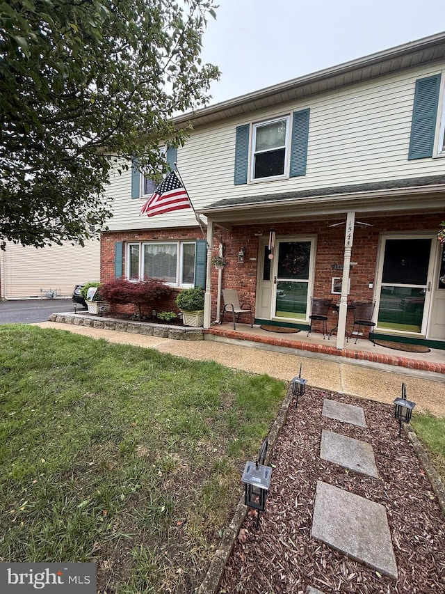 154 Bayshore Dr, Barnegat, NJ 08005 - view of front of house featuring brick siding, covered porch, and a front yard