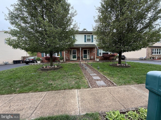 154 Bayshore Dr, Barnegat, NJ 08005 - obstructed view of property with brick siding, a front yard, and covered porch