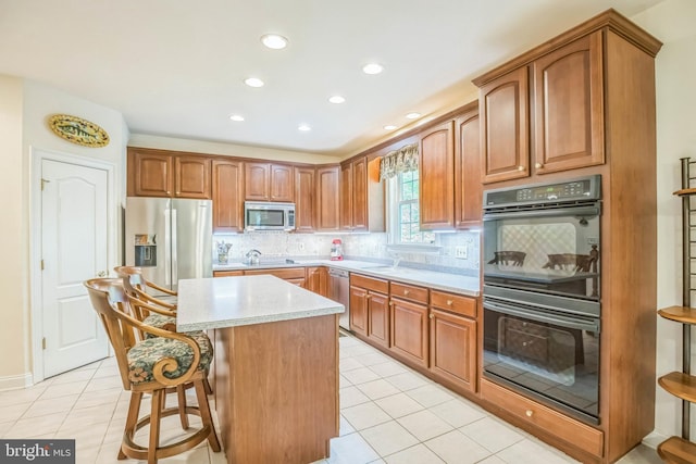 40801 Kiskadee Ln, Leonardtown, MD 20650 - kitchen with appliances with stainless steel finishes, light tile patterned flooring, a kitchen island, tasteful backsplash, and recessed lighting