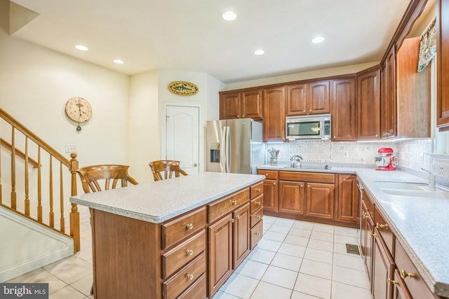 40801 Kiskadee Ln, Leonardtown, MD 20650 - kitchen with appliances with stainless steel finishes, a sink, light tile patterned floors, light countertops, and tasteful backsplash