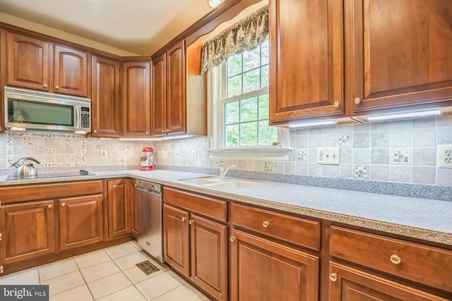 40801 Kiskadee Ln, Leonardtown, MD 20650 - kitchen with stainless steel appliances, a sink, light tile patterned floors, and light countertops