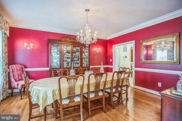 40801 Kiskadee Ln, Leonardtown, MD 20650 - dining area featuring a chandelier, ornamental molding, wood finished floors, and baseboards