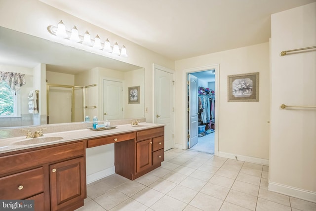 40801 Kiskadee Ln, Leonardtown, MD 20650 - bathroom with double vanity, a shower stall, tile patterned flooring, a spacious closet, and baseboards