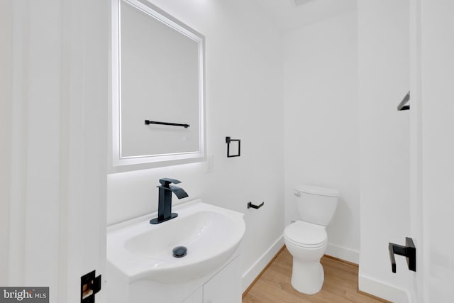 5318 5th St NW, Washington, DC 20011 - bathroom featuring toilet, wood finished floors, vanity, and baseboards