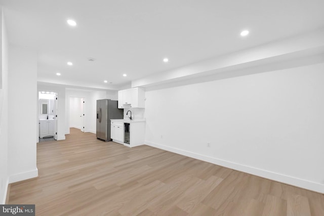 5318 5th St NW, Washington, DC 20011 - unfurnished living room featuring baseboards, light wood-type flooring, recessed lighting, and beverage cooler