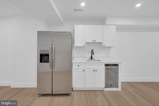 5318 5th St NW, Washington, DC 20011 - kitchen featuring stainless steel fridge with ice dispenser, a sink, light wood-style flooring, baseboards, and recessed lighting
