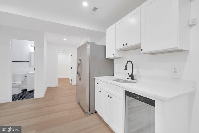 5318 5th St NW, Washington, DC 20011 - kitchen featuring beverage cooler, a sink, white cabinetry, recessed lighting, and light wood-style flooring