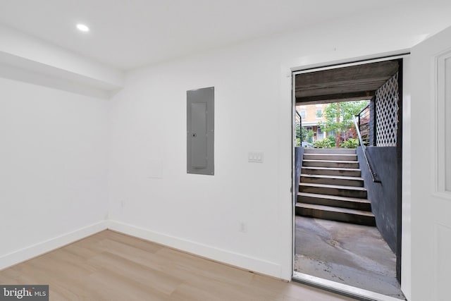 5318 5th St NW, Washington, DC 20011 - empty room with electric panel, light wood-type flooring, baseboards, recessed lighting, and stairway