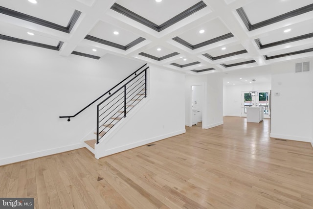 5318 5th St NW, Washington, DC 20011 - unfurnished living room featuring beamed ceiling, coffered ceiling, light wood-style floors, stairway, and baseboards