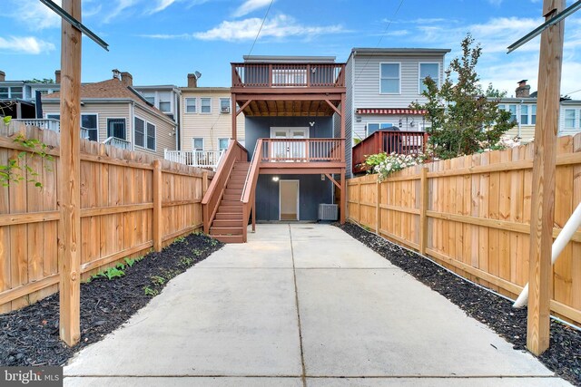 5318 5th St NW, Washington, DC 20011 - back of property featuring a fenced backyard, stairway, cooling unit, and a wooden deck