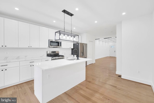 5318 5th St NW, Washington, DC 20011 - kitchen featuring stainless steel appliances, an island with sink, white cabinets, light countertops, and recessed lighting