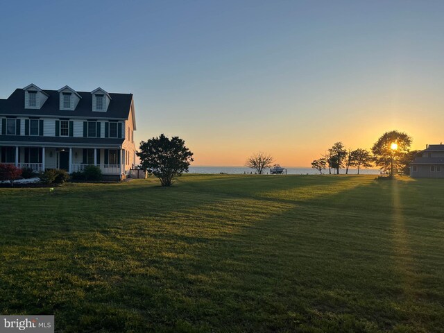 5520 Leeward Ln, Tilghman, MD 21671 - yard at dusk with covered porch, a water view, and a lawn