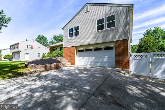 1222 Kings Tree Dr, Bowie, MD 20721 - view of front of property featuring brick siding, concrete driveway, a gate, and a garage