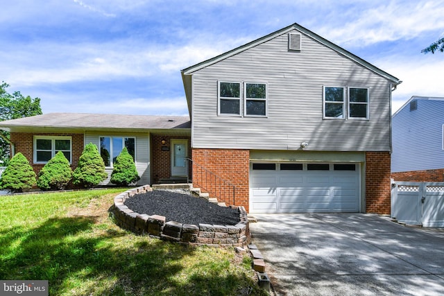 1222 Kings Tree Dr, Bowie, MD 20721 - tri-level home with brick siding, an attached garage, and driveway